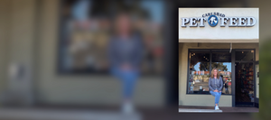 Carlsbad staff member sitting outside in front of the store